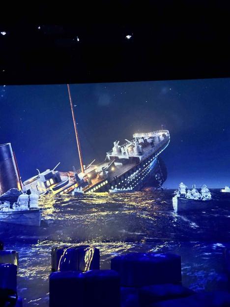 Titanic sinking with lifeboats.