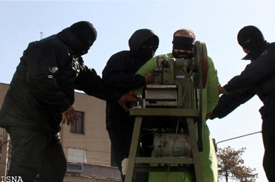 A blindfolded man's fingers being amputated by a circular saw.