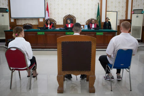 Courtroom scene with defendants and judges.