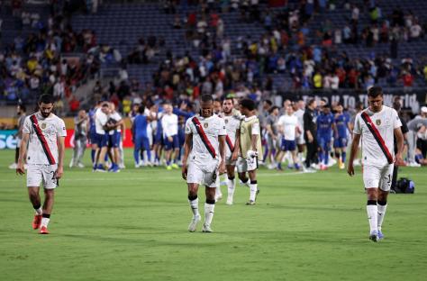 Manchester City players walking off the field after a game.