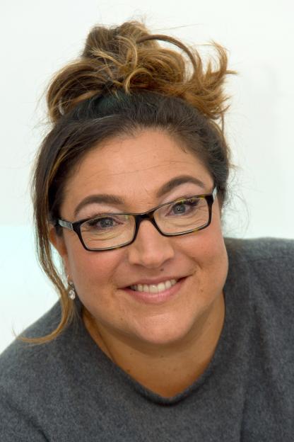 Jo Frost in a purple jacket, arms crossed.