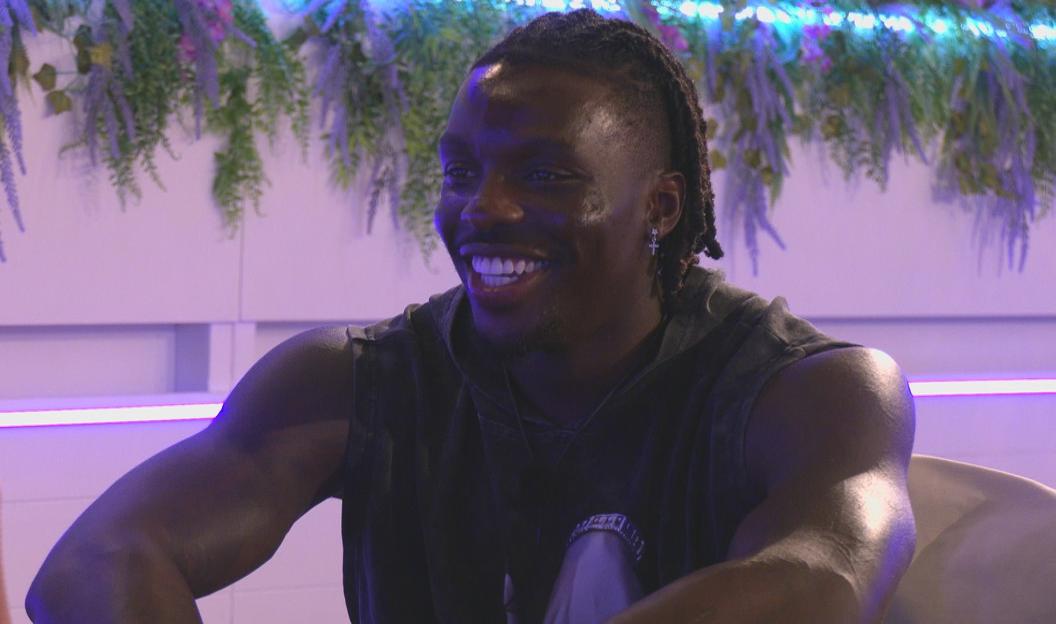 Dejon from Love Island smiling.