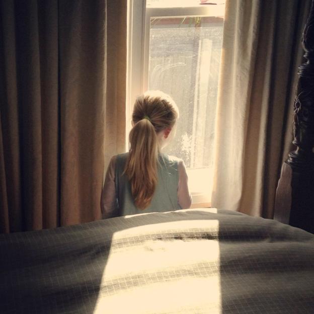 Girl looking out window.