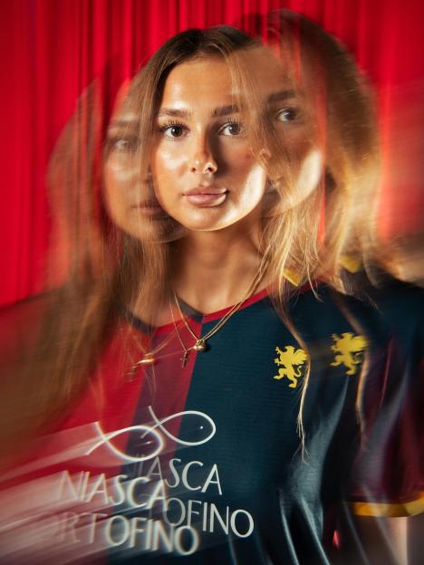 Portrait of a woman in a soccer jersey with motion blur.