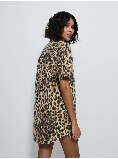 Woman in leopard print shirt dress.