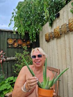 Woman holding an aloe vera plant.