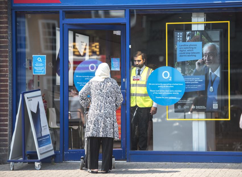 Security guard at an O2 store entrance.