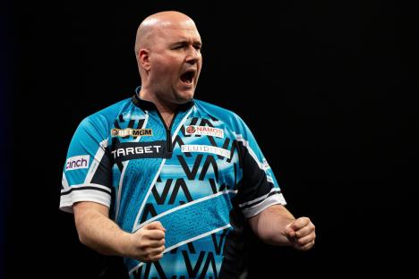 Rob Cross celebrating at a darts match.