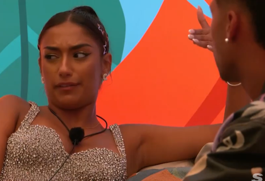 Screenshot of a woman and a man having a conversation.