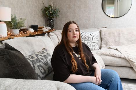 Woman sitting on a couch.