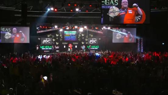 A large crowd cheering at a darts championship.