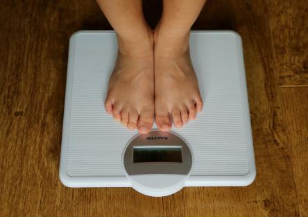Child's feet on a scale.