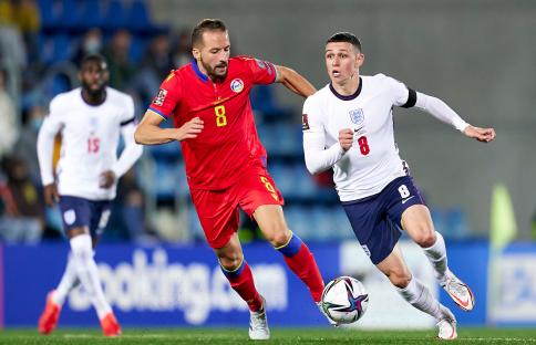 Phil Foden of England running with the ball during a soccer match.