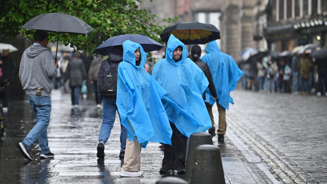 Tourists in rain ponchos on the Royal Mile in Edinburgh.