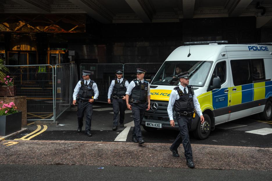 Police officers outside a hotel.