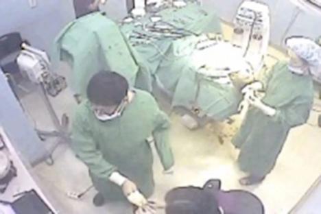 Surgeons performing surgery in an operating room.