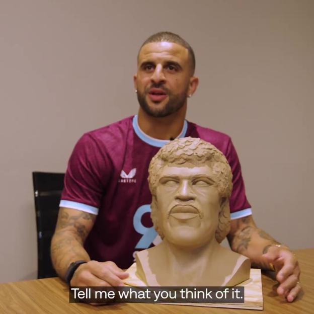 Kyle Walker holding a clay bust of himself.
