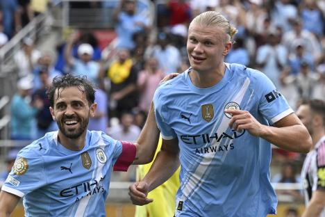 Erling Haaland and Bernardo Silva celebrating a goal.