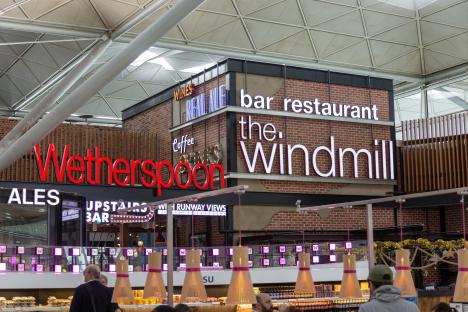 Neon sign for The Windmill, a Wetherspoon's pub at Stansted Airport.