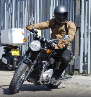 A man riding a Triumph Bonneville motorcycle.