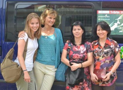 Four women standing by a van, one of whom is Annette Herfkens, the sole survivor of a 1992 plane crash.