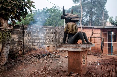 Statue of a seated bull-like figure at a Voodoo festival in Ouidah, Benin.