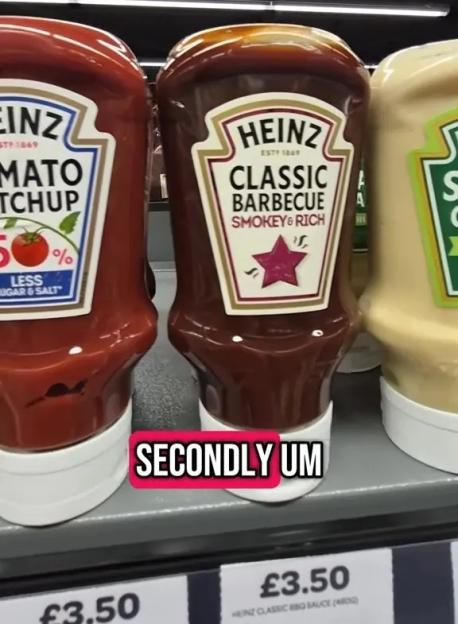 Heinz ketchup and barbecue sauce bottles on a shelf.