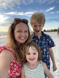 Woman and two children at the beach.