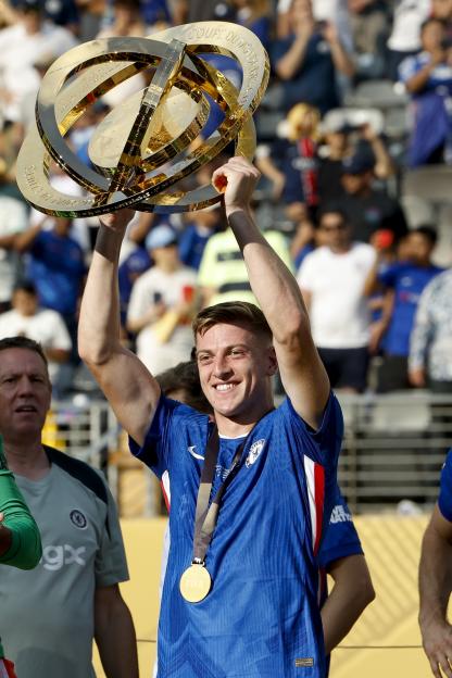 A Chelsea player lifts the FIFA Club World Cup trophy.