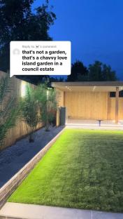 Nighttime photo of a garden with artificial turf, wooden pergola, and palm trees; comment overlaid saying it resembles a