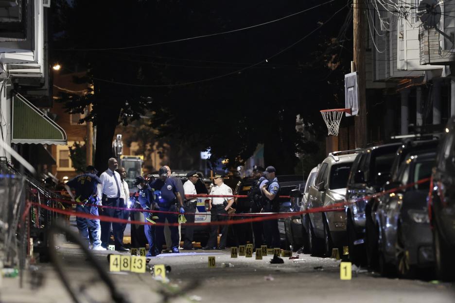 Police investigating a night shooting scene.