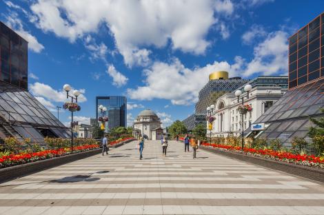 People walking on a paved walkway in the West Midlands.