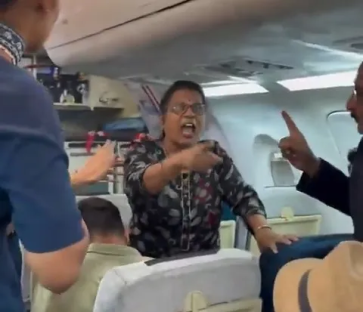 A woman arguing with others on an airplane.