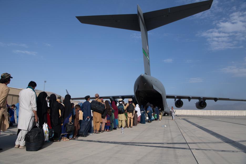 Afghan refugees boarding a US Air Force C-17 Globemaster III at Hamid Karzai International Airport.