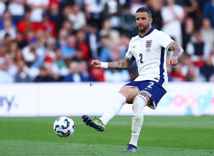 Kyle Walker of England kicking a soccer ball.