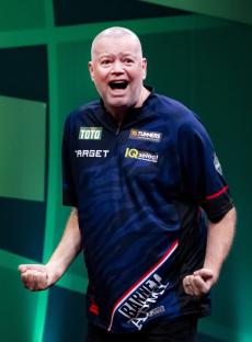 Raymond van Barneveld celebrating during a darts match.