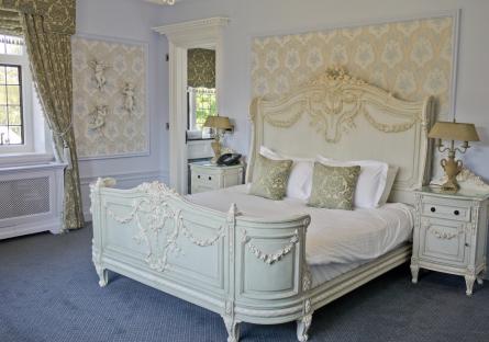 Ornate bed in a hotel room.