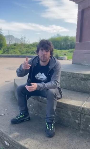 X Factor finalist Anthony Russel sits outdoors, gesturing.