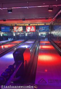 Bowling alley with colorful lighting.