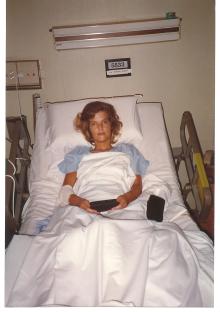 Woman in a hospital bed.