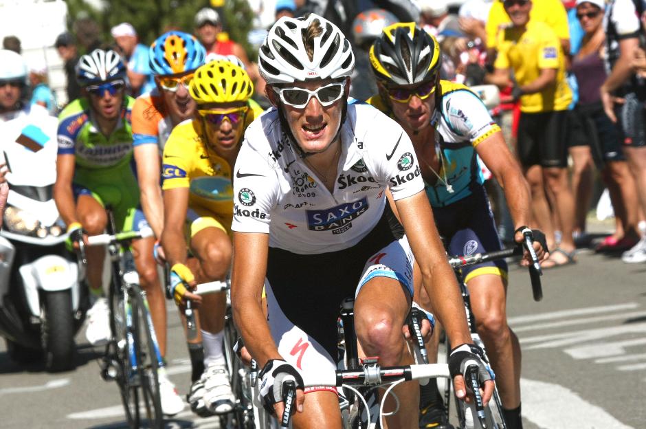 Cyclist in white jersey leading a pack during a race.