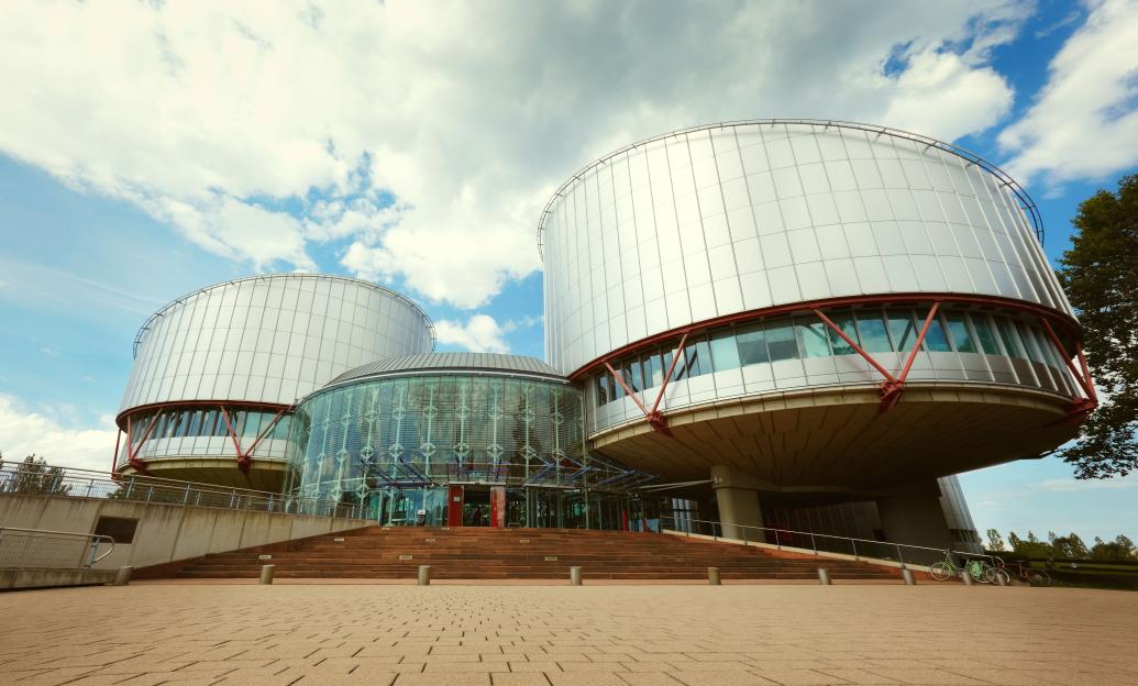 a large building with a blue sky in the background
