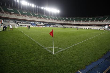 Soccer players on a field at night during a CAF Champions League match.
