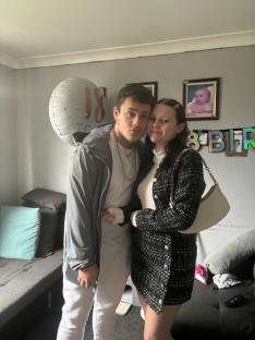 Young couple posing for a photo at a birthday party.