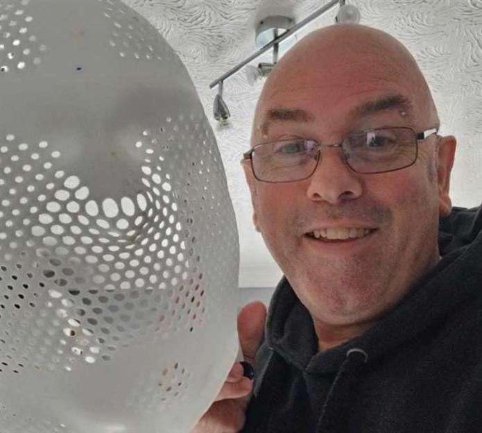 Man holding a radiotherapy mask.