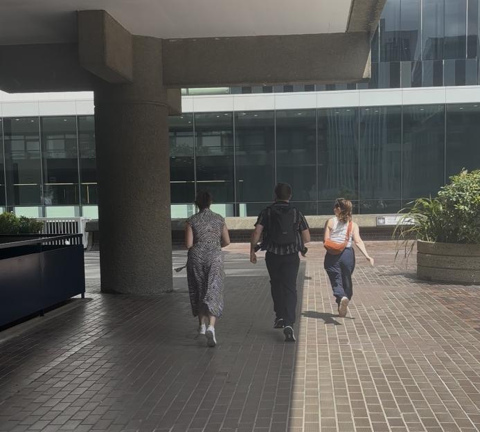 Three people walking away from the camera.
