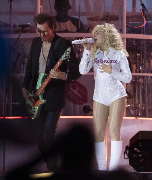 Sabrina Carpenter and a bassist on stage at Hyde Park.
