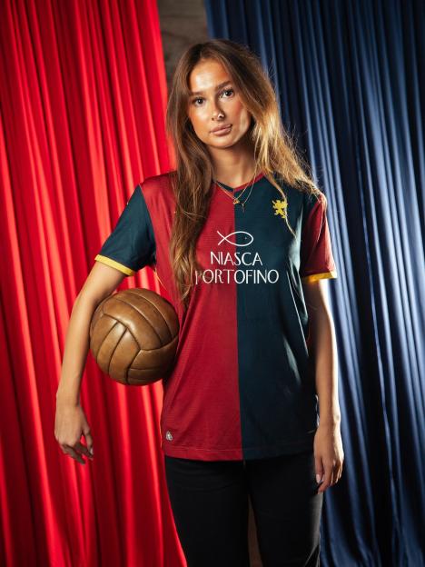 Woman holding a Niasca Portofino soccer jersey.