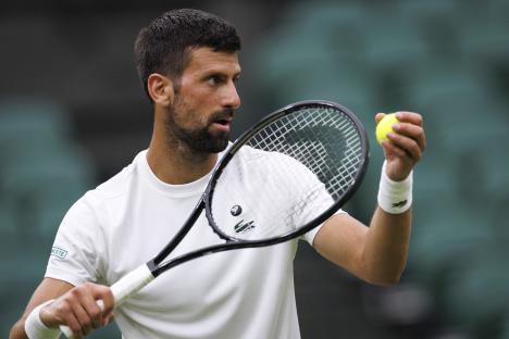 Novak Djokovic practicing tennis at Wimbledon.