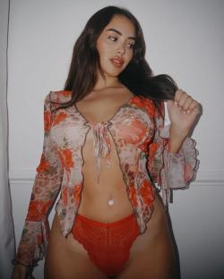 Marnie Simpson in a floral top and red underwear.